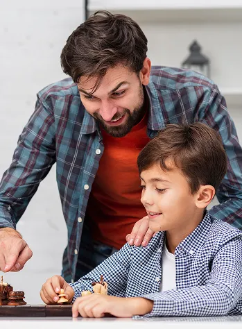 father-teaching-son-play-chess