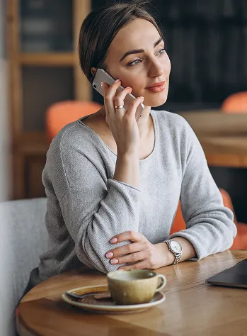 woman-sitting-cafe-drinking-coffee-working-computer